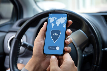 male hand hold phone with app vpn screen in car
