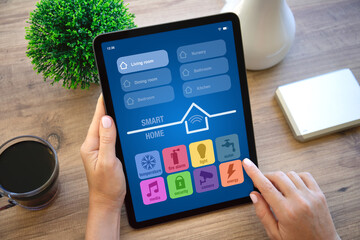 woman hands hold computer tablet with application smart home screen