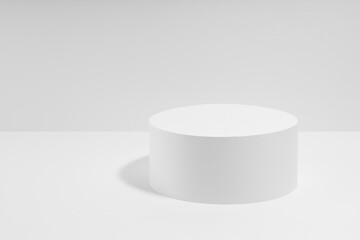 Abstract one white round podium for cosmetic products, mockup on white background. White stage template in elegant simplicity style for showing products, advertising, design, poster, text, card.