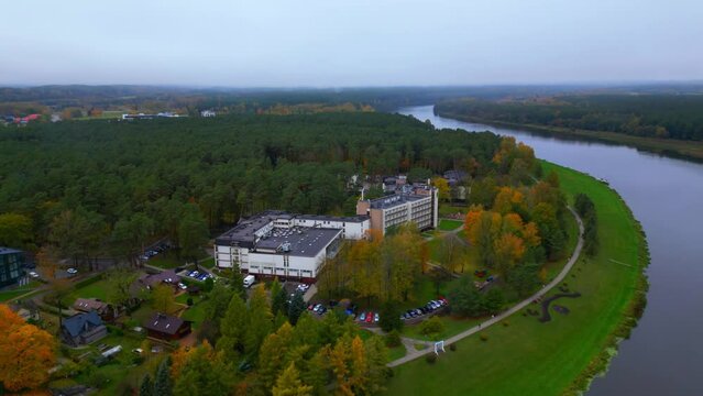 Exterior aerial of Egles sanatorija Birstonas next to river countryside