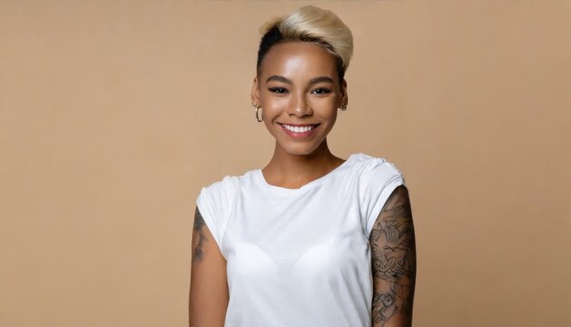 Smiling blond pretty smiling girl beauty female gen z model with short blonde hair beautiful face healthy skin and tattoo looking at camera wearing white top isolated at beige background