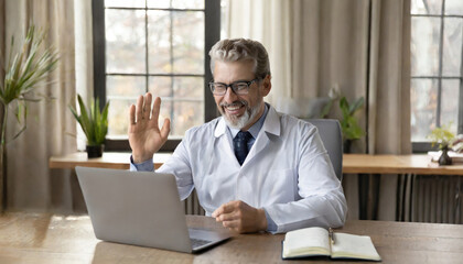 Happy old male doctor physician talking, consulting patient online by webcam video call on laptop computer. Telemedicine conference virtual tele meeting. E appointment, telehealth therapy concept - obrazy, fototapety, plakaty