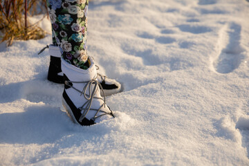 Walking in the snow in insulated waterproof snow boots.