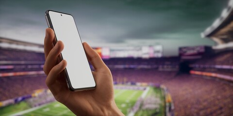 CU Caucasian man using his phone during American football game on a huge stadium