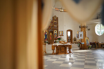 Fototapeta na wymiar The interior of the Greek Catholic Church, throne, iconostasis and other church objects.