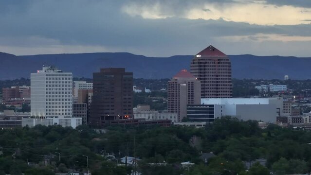 Albuquerque skyline at dawn. Aerial establishing shot with zoom lens. New Mexico city during sunrise.