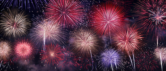 Naklejka premium fireworks in night sky, holiday background, bright colorful lights