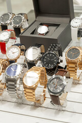 Elegant watch in a store window. Expensive and status gift. Close-up. Vertical.