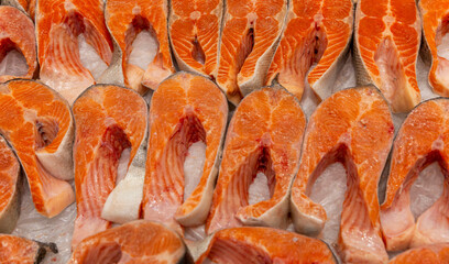 Steaks of raw red fish on an ice counter. Healthy dietary products. Close-up. Top view.