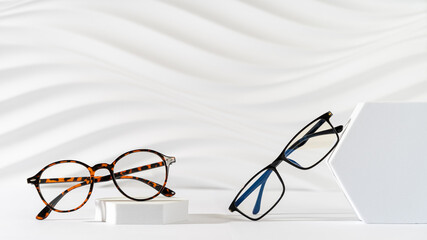 Two pairs of plastic eyeglass frames on white background. Minimalism, eyewear fashion concept....
