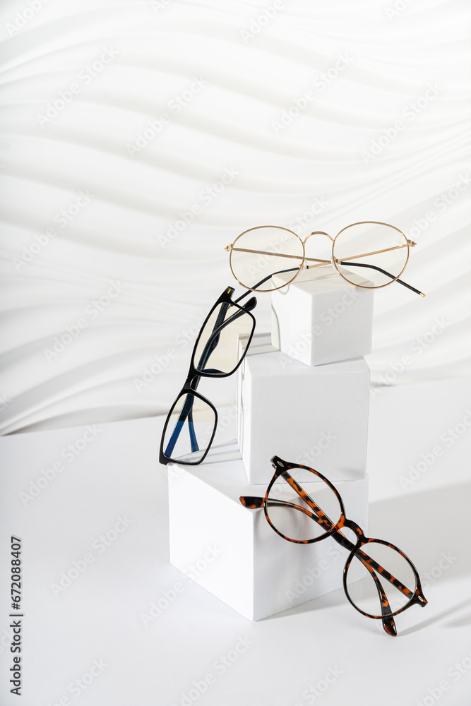 Wall mural trendy eyeglasses in plastic and metallic frame on a white background. close up. sunglasses and spec