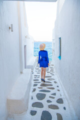 Woman in blue dress at the Streets of old town Mykonos during a vacation in Greece, Little Venice Mykonos Greece