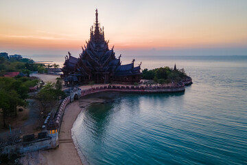Sanctuary of Truth, Pattaya, Thailand, wooden temple by the ocean at sunset on the beach of Pattaya