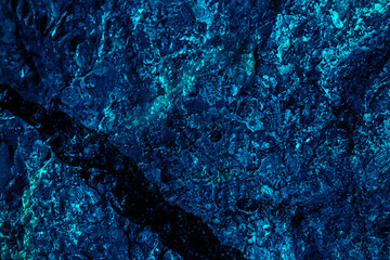 Black dark purple blue texture background for design. Toned rough concrete surface. A painted old building wall with cracks. Distressed, broken, crushed, collapsed.