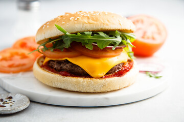 Traditional homemade cheeseburger with arugula