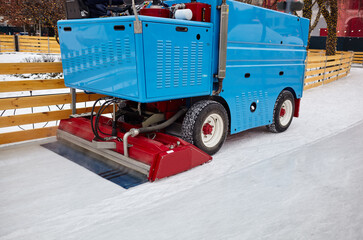 Resurfacing machine cleans ice. Special machine ice harvester cleans the ice rink