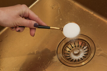 Cleaning kitchen sink with bakIng soda to keep sinks draining well and prevent clogs. Safe,...