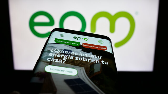 Stuttgart, Germany - 10-29-2023: Mobile phone with website of Colombian company Empresas Publicas de Medellin (EPM) in front of business logo. Focus on top-left of phone display.