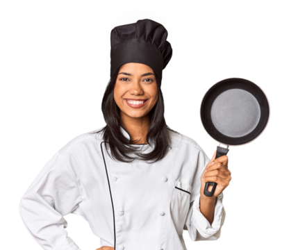 Young Filipina chef holding pan by handle showing a copy space on a palm and holding another hand on waist.