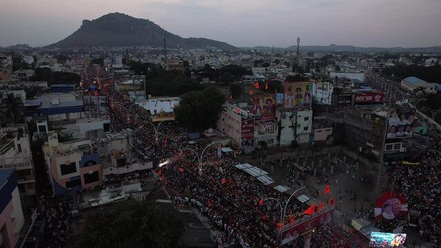 Aerial top view of massive crowd gathered on the city street for a Hindu festival