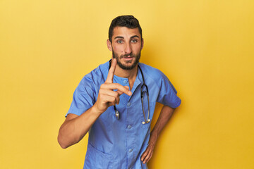 Young Hispanic male nurse Young Hispanic male nurse poses confidently having an idea, inspiration...