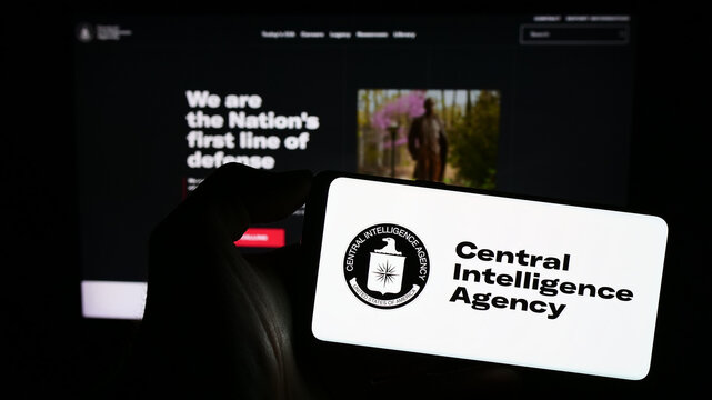 Stuttgart, Germany - 10-29-2023: Person holding smartphone with logo of US Central Intelligence Agency (CIA) in front of website. Focus on phone display.