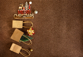 Fototapeta na wymiar Paper bags and gift for christmas on brown background