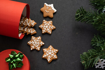 Gingerbread cookies for christmas spilling out of a red gift box