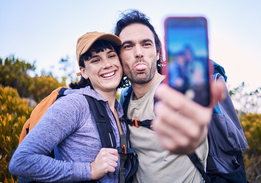 Hiking, silly selfie and couple on mountain for adventure, holiday and journey on mountain. Travel, dating and happy man and woman take goofy picture for memories, trekking and backpacking outdoors