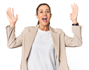 Entrepreneur in business attire, studio portrait receiving a pleasant surprise, excited and raising hands.