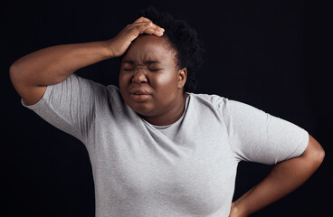 Frustrated black woman, headache and anxiety in studio of stress, trauma or problem on dark background. Face of confused model in burnout, brain fog or crazy fear of pain, depression or mental health