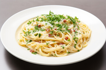  A white plate holds spaghetti carbonara, garnished with a sprinkle of parsley and grated Parmesan cheese