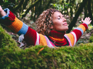 Profile of a relaxed woman breathing fresh air in a green forest. Environment and healthy lifestyle female people in outdoor leisure activity opening arms and hugging nature with love. Forest travel