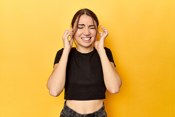 covering ears with hands. - obrazy, fototapety, plakaty