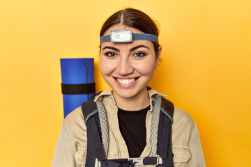 Active Caucasian woman with backpack and headlight