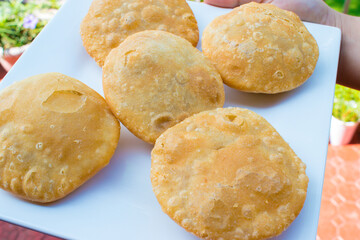 Kachori Indian Traditional Snacks on White plate in hand. selective focus on subject
