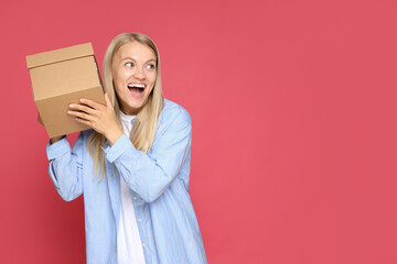 Attractive blonde with a cardboard box in her hands