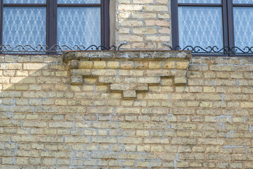 windows with decorative elements on an old wooden or brick building