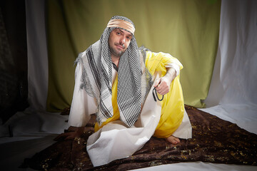 An imposing man in stylized eastern attire, a Sheikh or Sultan in Israel, Palestine, and Iran. Photoshoot with a male model