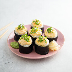 Homemade sushi rolls with roe topping