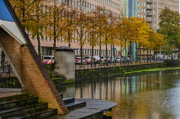 Wandaufkleber Rotterdam, The Netherlands, October 31, 2023: Delftsevaart canal in autumn with the main police office in the background © Frans