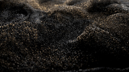 Black glitter with gold flecks. Golden loosened sand on ground.