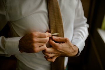 A young businessman is getting dressed
 for a meeting. The beginning of a new working week.

