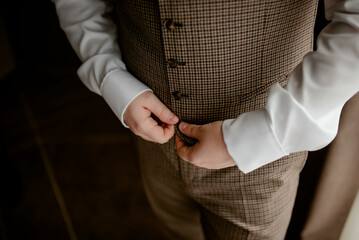 A young businessman is getting dressed
 for a meeting. The beginning of a new working week.

