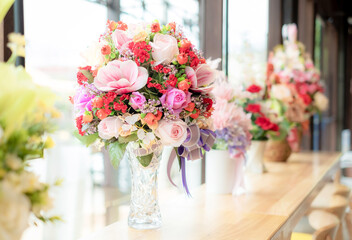 Celebrate Artificial bouquet  flowers close-up. Decoration of roses, flowers and ornamental plants, modern and luxury artificial bouquet of colorful flowers for graphic design.