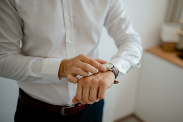 A young businessman is getting dressed
 for a meeting. The beginning of a new working week.

