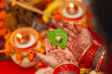 Beautiful hands of an Indian woman with betel nut along with betel leaf performing puja rituals....