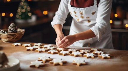 Fotobehang Christmas and New Year celebration conventions. Family domestic pastry shop, cooking conventional merry desserts. Lady cutting treats of crude gingerbread mixture © Khalida
