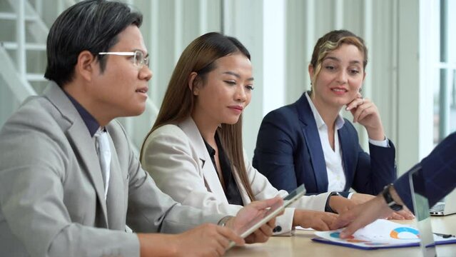 asian business woman focused to listening carefully colleague discussing or talking in meeting with diversity coworker on table in meeting room at office