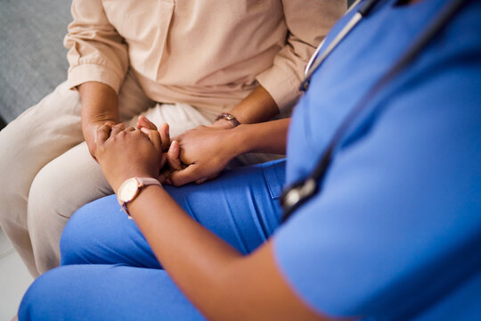 Hands, Medical Or Empathy With A Nurse And Patient In A Living Room For Love, Trust Or Care During Treatment. Healthcare, Support And A Black Woman Medicine Professional Comforting A Clinic Resident